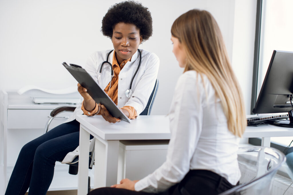 african female physician and young girl patient di QWUNMZA scaled
